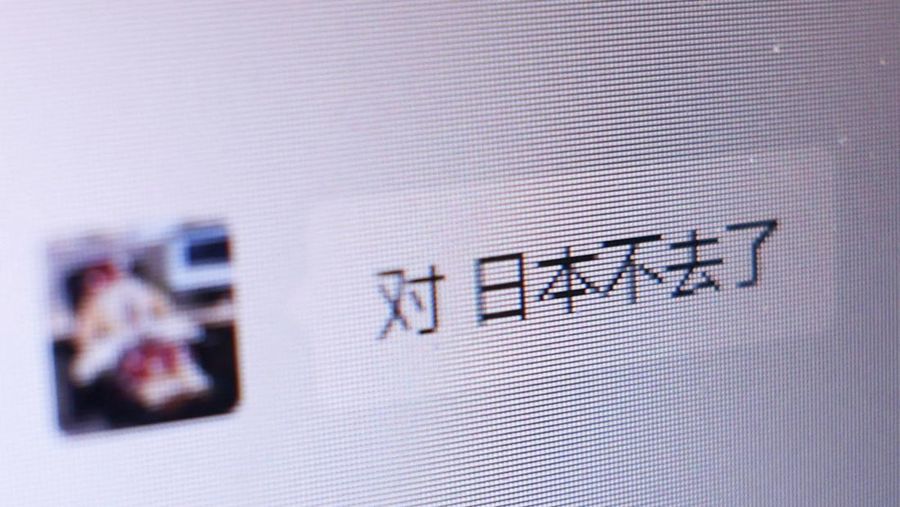 A Chinese chat message between a travel agency staff member and a customer reading 'I won't go to Japan', as a part of messages announcing trip cancellations from the customer, appears on a computer screen at East Japan International Travel Service Co. , a Tokyo-based travel agency, amid escalating tension between China and Japan, in Tokyo, Japan November 18, 2025.  REUTERS/Issei Kato