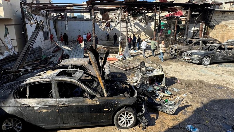 Masyarakat dan paramedis berkumpul di lokasi serangan Israel yang menewaskan beberapa orang kemarin malam, menurut Kementerian Kesehatan Lebanon, di dalam kamp pengungsi Palestina Ain al-Hilweh di kota selatan Sidon, Lebanon, 19 November 2025. (REUTERS/Ali Hankir)