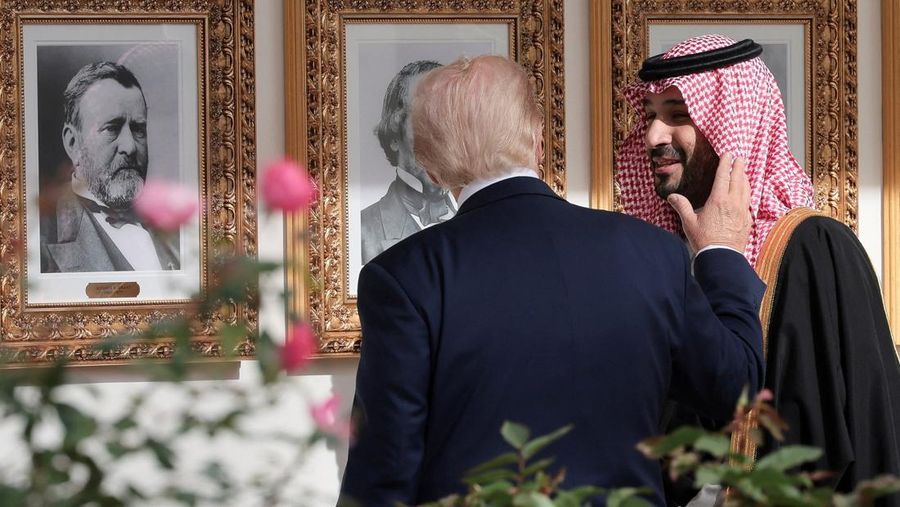 Saudi Crown Prince and Prime Minister Mohammed bin Salman laughs as U.S. President Donald Trump speaks while shaking hands during a meeting in the Oval Office at the White House in Washington, D.C., U.S., November 18, 2025.  REUTERS/Evelyn Hockstein