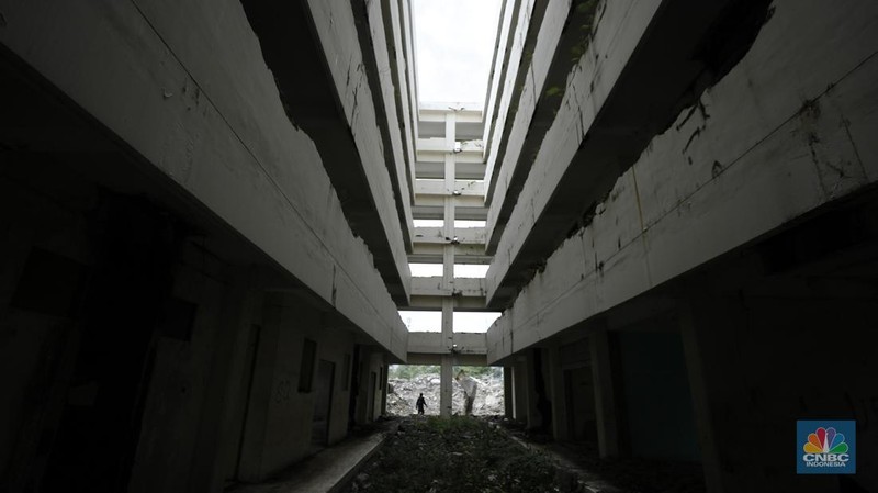 Pekerja menggunakan alat berat membongkar bangunan Rusunawa Marunda yang terbengkalai di Cilincing, Jakarta, Kamis (20/11/2025). (CNBC Indonesia/Tri Susilo)