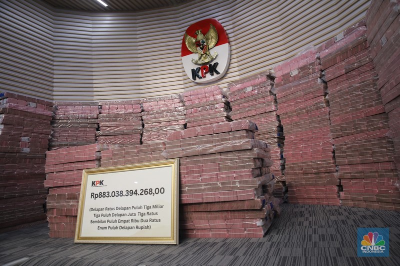 Petugss memindahkan uang di ruang konferensi pers Gedung  Merah Putih KPK, Jakarta, Kamis (20/11/2025). (CNBC Indonesia/Faisal Rahman)