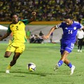 Soccer Football - FIFA World Cup - CONCACAF Qualifiers - Group B - Jamaica v Curacao - National Stadium Independence Park, Kingston, Jamaica - November 18, 2025 Curacao's Kenji Gorre in action with Jamaica's Dexter Lembikisa REUTERS/Gilbert Bellamy