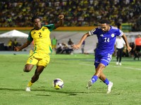 Soccer Football - FIFA World Cup - CONCACAF Qualifiers - Group B - Jamaica v Curacao - National Stadium Independence Park, Kingston, Jamaica - November 18, 2025 Curacao's Kenji Gorre in action with Jamaica's Dexter Lembikisa REUTERS/Gilbert Bellamy
