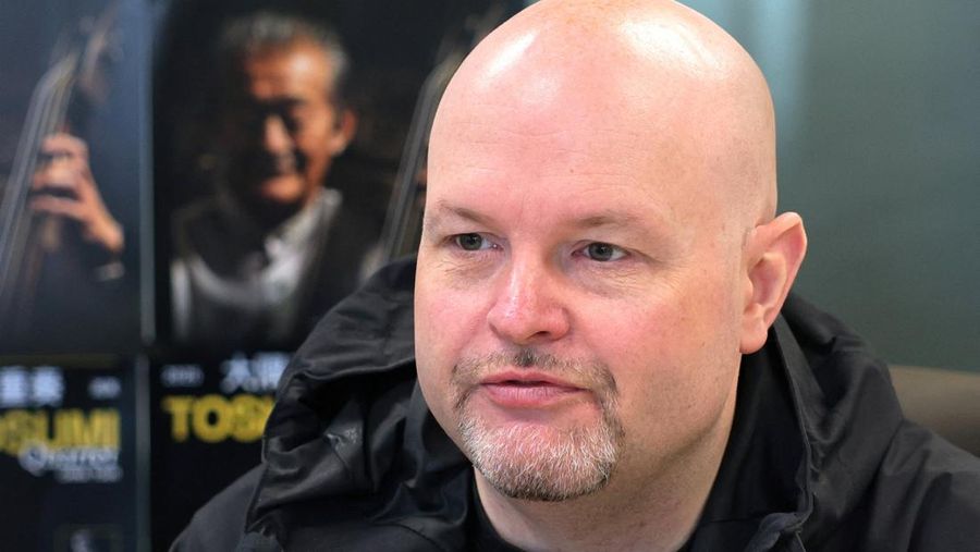 A man passes by the entrance to DDC music club featuring concert posters including Japanese musician Toshio Osumi in Beijing, China, November 21, 2025. REUTERS/Maxim Shemetov