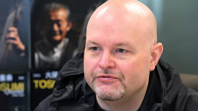 A man passes by the entrance to DDC music club featuring concert posters including Japanese musician Toshio Osumi in Beijing, China, November 21, 2025. REUTERS/Maxim Shemetov
