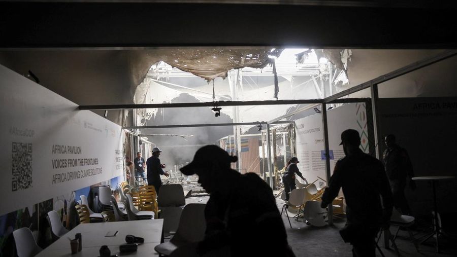 Orang-orang menggunakan alat pemadam kebakaran untuk memadamkan api di Paviliun Negara-negara di Zona Biru pada Konferensi Perubahan Iklim Perserikatan Bangsa-Bangsa (COP30) di Belem, Brasil, 20 November 2025. (REUTERS/Douglas Pingituro)