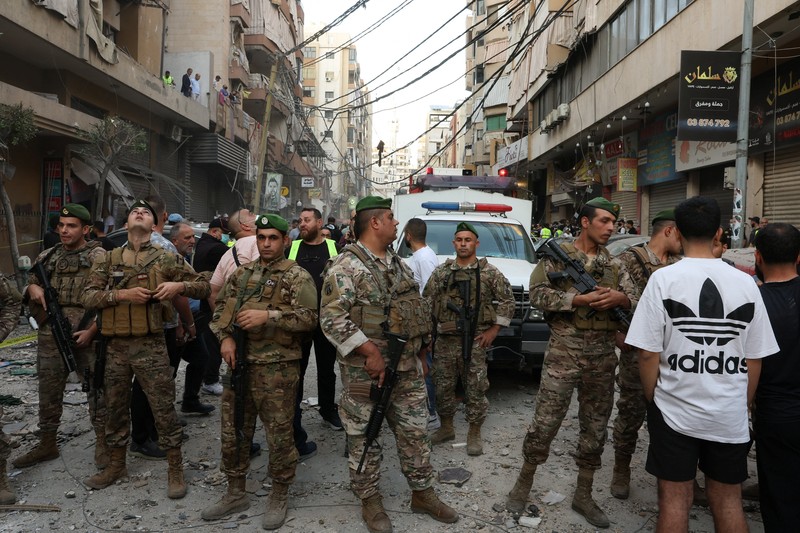 Members of the Lebanese army secure the area near the site of an Israeli strike, after Israeli military said on Sunday that it struck a militant from the Lebanese Iran-aligned Hezbollah group, in Beirut's southern suburbs, Lebanon November 23, 2025. REUTERS/Mohamed Azakir