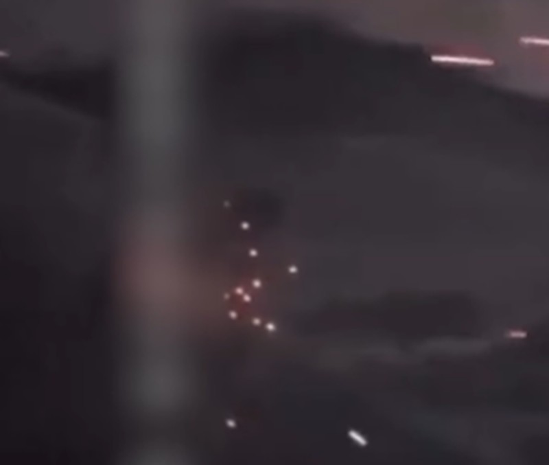 A person stands by an emergency vehicle as fire and smoke rise around the Shatura Power Station in Shatura, Russia, after Ukrainian drones struck the facility early Sunday, Moscow region governor Andrei Vorobyov said, in this still image taken from a social media video released November November 23, 2025. SOCIAL MEDIA/via REUTERS  THIS IMAGE HAS BEEN SUPPLIED BY A THIRD PARTY. NO RESALES. NO ARCHIVES. VERIFICATION LINES: - Reuters was able to confirm the location as buildings, signages and roadmap layout match with file images and satellite imagery. Date could not be independently verified. However, the governor of Moscow Region said on Telegram that Shatura Thermal Plant was attacked and caused fire this morning (November 23, 2025).