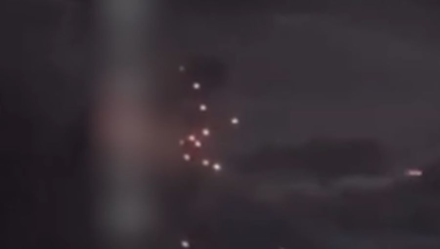 A person stands by an emergency vehicle as fire and smoke rise around the Shatura Power Station in Shatura, Russia, after Ukrainian drones struck the facility early Sunday, Moscow region governor Andrei Vorobyov said, in this still image taken from a social media video released November November 23, 2025. SOCIAL MEDIA/via REUTERS  THIS IMAGE HAS BEEN SUPPLIED BY A THIRD PARTY. NO RESALES. NO ARCHIVES. VERIFICATION LINES: - Reuters was able to confirm the location as buildings, signages and roadmap layout match with file images and satellite imagery. Date could not be independently verified. However, the governor of Moscow Region said on Telegram that Shatura Thermal Plant was attacked and caused fire this morning (November 23, 2025).