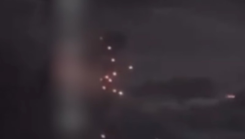 A person stands by an emergency vehicle as fire and smoke rise around the Shatura Power Station in Shatura, Russia, after Ukrainian drones struck the facility early Sunday, Moscow region governor Andrei Vorobyov said, in this still image taken from a social media video released November November 23, 2025. SOCIAL MEDIA/via REUTERS  THIS IMAGE HAS BEEN SUPPLIED BY A THIRD PARTY. NO RESALES. NO ARCHIVES. VERIFICATION LINES: - Reuters was able to confirm the location as buildings, signages and roadmap layout match with file images and satellite imagery. Date could not be independently verified. However, the governor of Moscow Region said on Telegram that Shatura Thermal Plant was attacked and caused fire this morning (November 23, 2025).