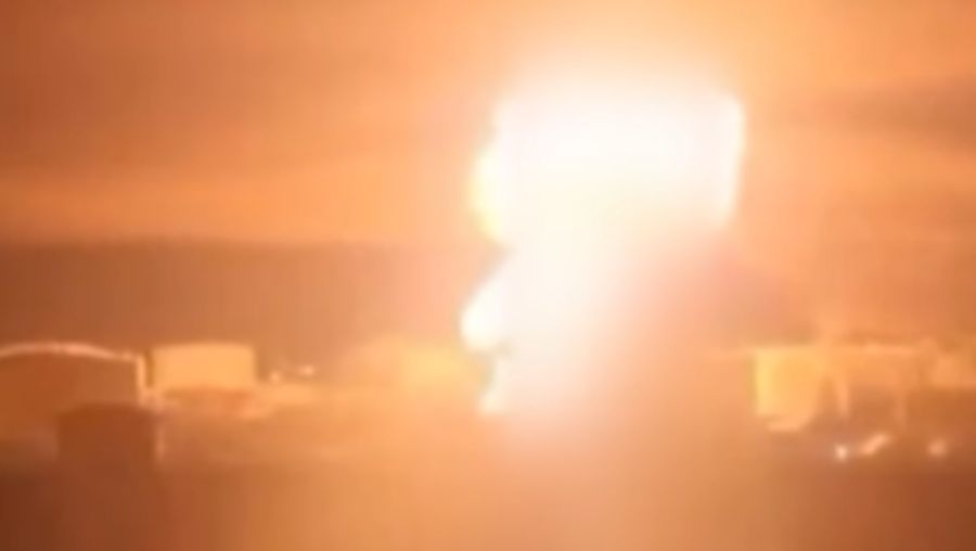 A person stands by an emergency vehicle as fire and smoke rise around the Shatura Power Station in Shatura, Russia, after Ukrainian drones struck the facility early Sunday, Moscow region governor Andrei Vorobyov said, in this still image taken from a social media video released November November 23, 2025. SOCIAL MEDIA/via REUTERS  THIS IMAGE HAS BEEN SUPPLIED BY A THIRD PARTY. NO RESALES. NO ARCHIVES. VERIFICATION LINES: - Reuters was able to confirm the location as buildings, signages and roadmap layout match with file images and satellite imagery. Date could not be independently verified. However, the governor of Moscow Region said on Telegram that Shatura Thermal Plant was attacked and caused fire this morning (November 23, 2025).