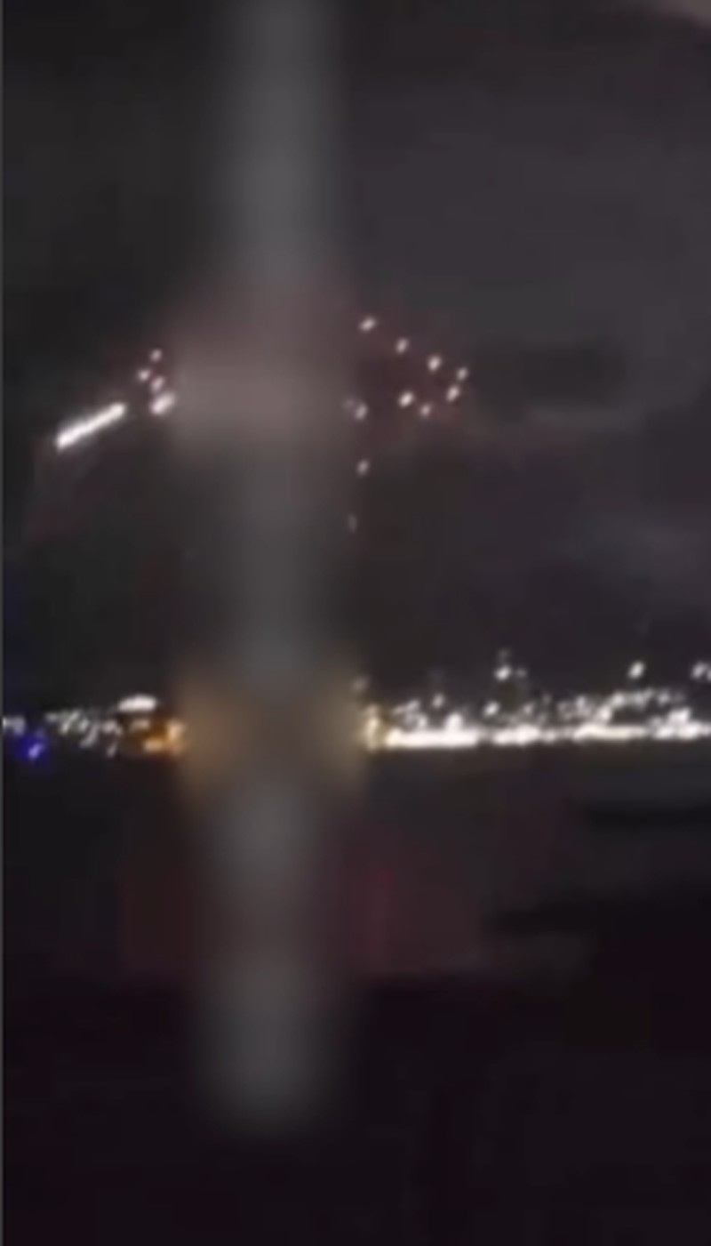 A person stands by an emergency vehicle as fire and smoke rise around the Shatura Power Station in Shatura, Russia, after Ukrainian drones struck the facility early Sunday, Moscow region governor Andrei Vorobyov said, in this still image taken from a social media video released November November 23, 2025. SOCIAL MEDIA/via REUTERS  THIS IMAGE HAS BEEN SUPPLIED BY A THIRD PARTY. NO RESALES. NO ARCHIVES. VERIFICATION LINES: - Reuters was able to confirm the location as buildings, signages and roadmap layout match with file images and satellite imagery. Date could not be independently verified. However, the governor of Moscow Region said on Telegram that Shatura Thermal Plant was attacked and caused fire this morning (November 23, 2025).