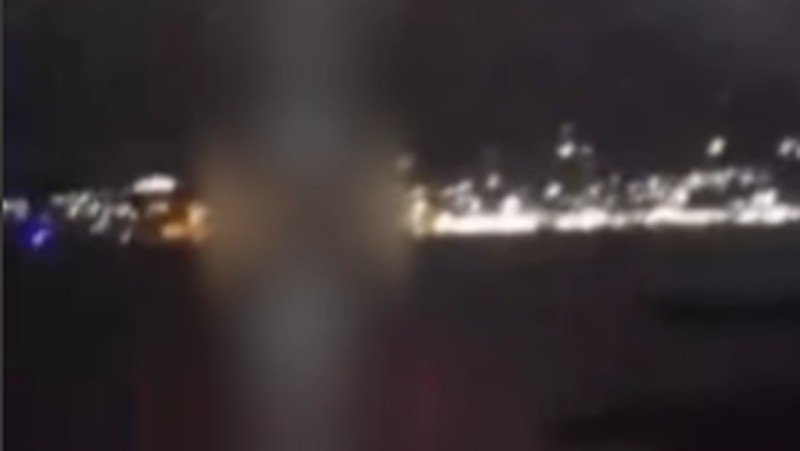 A person stands by an emergency vehicle as fire and smoke rise around the Shatura Power Station in Shatura, Russia, after Ukrainian drones struck the facility early Sunday, Moscow region governor Andrei Vorobyov said, in this still image taken from a social media video released November November 23, 2025. SOCIAL MEDIA/via REUTERS  THIS IMAGE HAS BEEN SUPPLIED BY A THIRD PARTY. NO RESALES. NO ARCHIVES. VERIFICATION LINES: - Reuters was able to confirm the location as buildings, signages and roadmap layout match with file images and satellite imagery. Date could not be independently verified. However, the governor of Moscow Region said on Telegram that Shatura Thermal Plant was attacked and caused fire this morning (November 23, 2025).