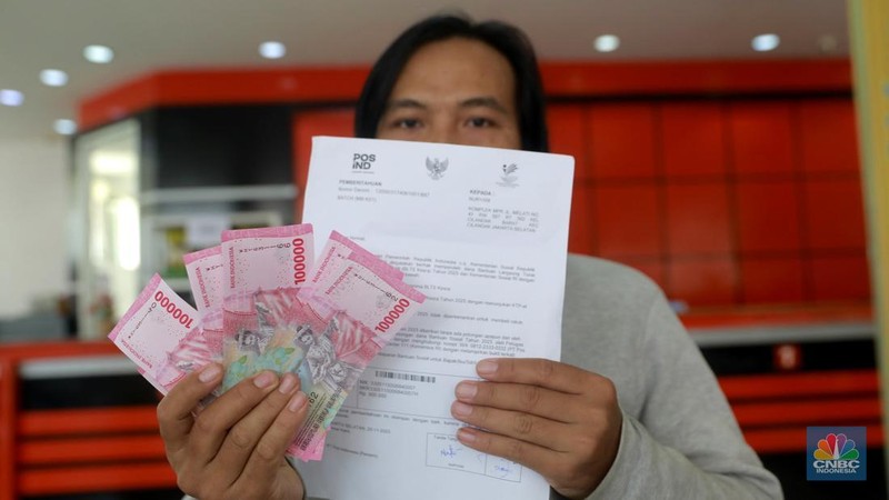 Warga penerima manfaat Bantuan Langsung Tunai Kesejahteraan Rakyat (BLT Kesra) 2025 menunjukan uang tunai yang diterima di Kantor Pos Fatmawati, Jakarta, Selasa (25/11/2025). (CNBC Indonesia/Muhammad Sabki)