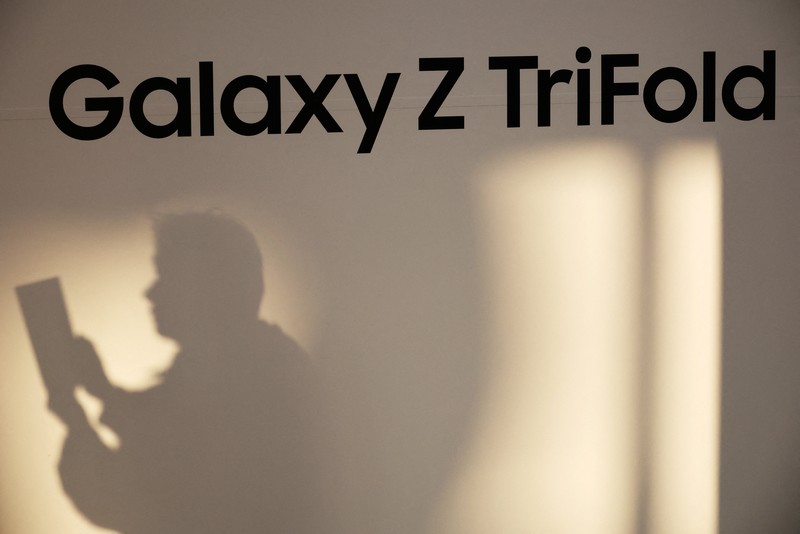 Seorang model berpose untuk foto dengan Galaxy Z TriFold selama acara di tokonya di Seoul, Korea Selatan, 2 Desember 2025. (REUTERS/Kim Hong-Ji)