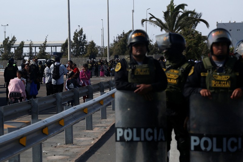 Polisi Peru berdiri di dekat Kompleks Perbatasan Chacalluta untuk memblokir migran Venezuela yang ingin meninggalkan Chili di tengah retorika anti-imigran dari kandidat presiden Chili sayap kanan Jose Antonio Kast, sementara Presiden Peru Jose Jeri berencana untuk mengumumkan keadaan darurat dan mengerahkan pasukan di perlintasan perbatasan, seperti yang terlihat dari Arica, Chili, 1 Desember 2025. (REUTERS/ Alexander Infante)