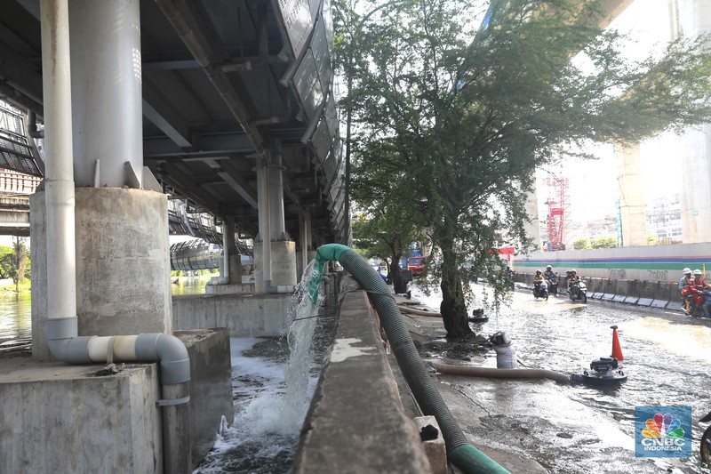 Sejumlah kendaraan roda dua dan roda empat melintasi banjir rob yang menggenangi Jalan RE Martadinata, Tanjung Priok, Jakarta Utara, Jumat (05/12/2025). (CNBC Indonesia/Muhammad Sabki)