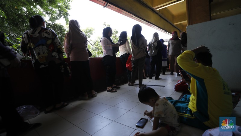 Antrean pengambilan bahan pangan dari program Kartu Jakarta Pintar (KJP) di kawasan Pasar Kebayoran Lama, Jakarta, Senin (8/12/2025). (CNBC Indonesia/Tri Susilo)