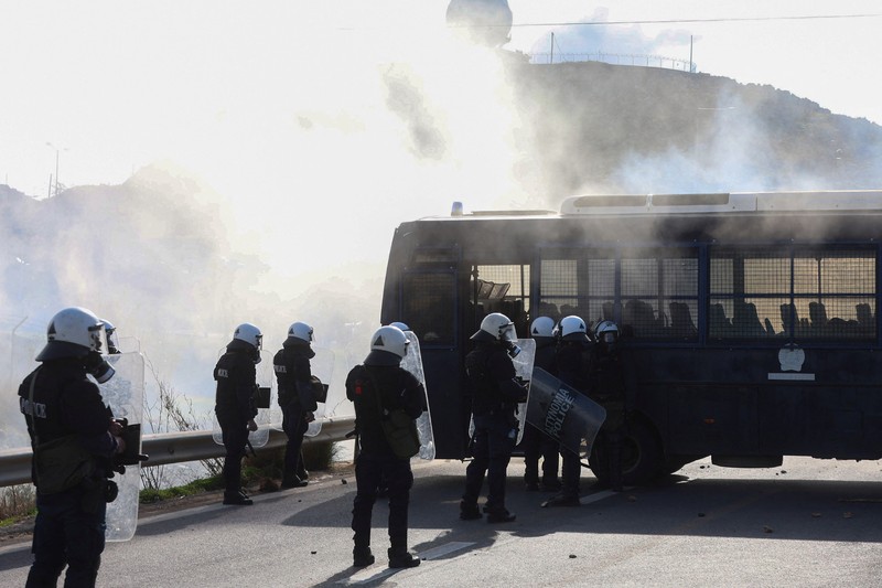 Greek farmers protesting over the delayed payment of European Union subsidies hurl stones amid tear gas at the Heraklion International Airport, in Heraklion, Crete island, Greece, December 8, 2025. REUTERS/Stefanos Rapanis     TPX IMAGES OF THE DAY