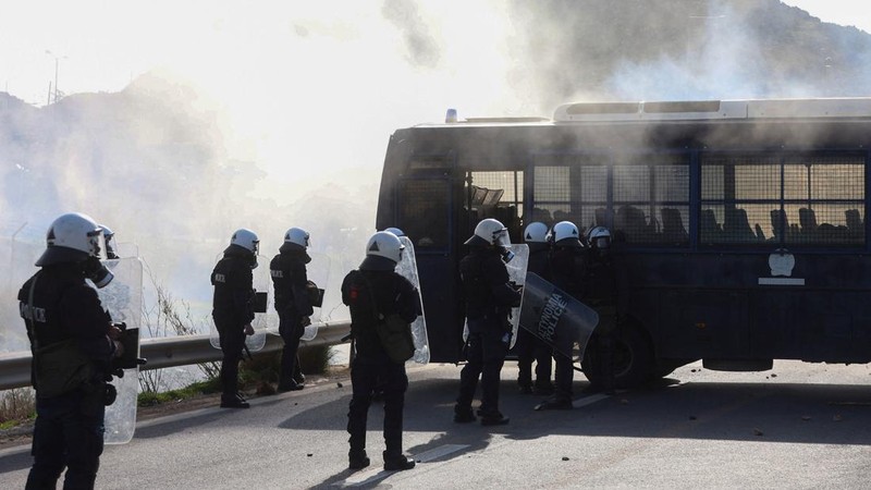 Greek farmers protesting over the delayed payment of European Union subsidies hurl stones amid tear gas at the Heraklion International Airport, in Heraklion, Crete island, Greece, December 8, 2025. REUTERS/Stefanos Rapanis     TPX IMAGES OF THE DAY