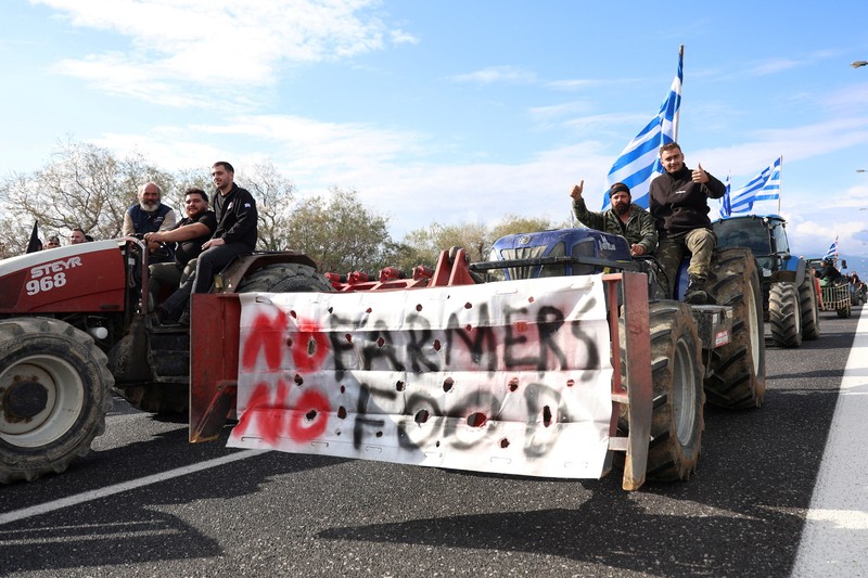 Greek farmers protesting over the delayed payment of European Union subsidies hurl stones amid tear gas at the Heraklion International Airport, in Heraklion, Crete island, Greece, December 8, 2025. REUTERS/Stefanos Rapanis     TPX IMAGES OF THE DAY