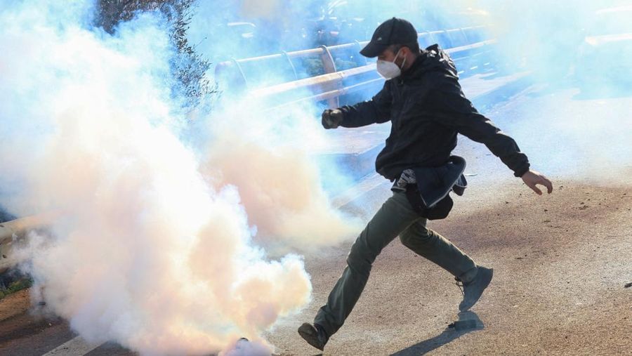 Greek farmers protesting over the delayed payment of European Union subsidies hurl stones amid tear gas at the Heraklion International Airport, in Heraklion, Crete island, Greece, December 8, 2025. REUTERS/Stefanos Rapanis     TPX IMAGES OF THE DAY