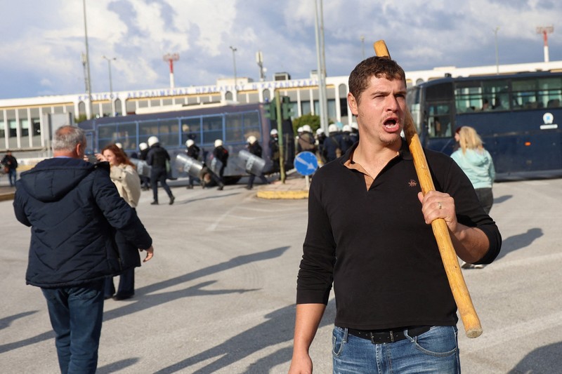 Greek farmers protesting over the delayed payment of European Union subsidies hurl stones amid tear gas at the Heraklion International Airport, in Heraklion, Crete island, Greece, December 8, 2025. REUTERS/Stefanos Rapanis     TPX IMAGES OF THE DAY
