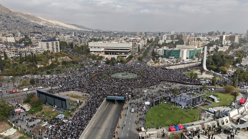 A drone view shows people gathering on the day of a military parade, as Syrians mark the first anniversary of Bashar al-Assad&#039;s fall, in Damascus, Syria December 8, 2025. REUTERS/Khalil Ashawi
