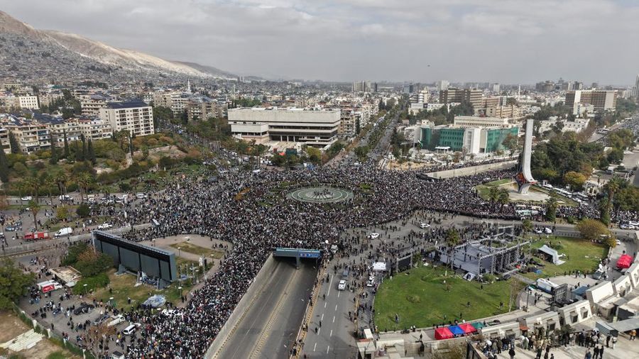 A drone view shows people gathering on the day of a military parade, as Syrians mark the first anniversary of Bashar al-Assad's fall, in Damascus, Syria December 8, 2025. REUTERS/Khalil Ashawi