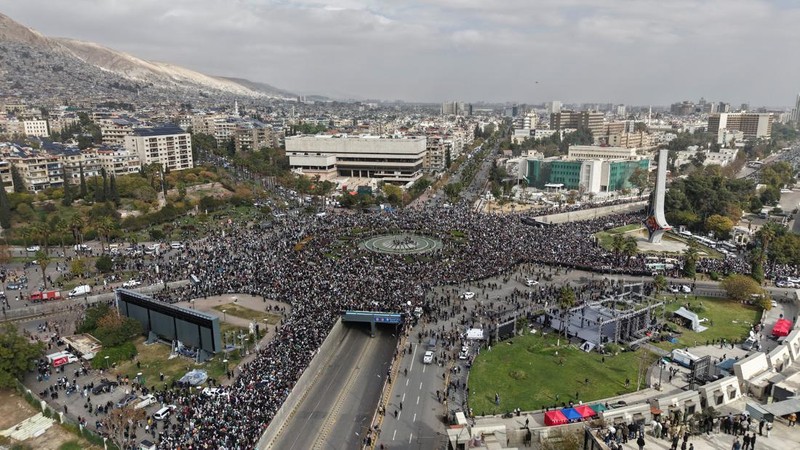 A drone view shows people gathering on the day of a military parade, as Syrians mark the first anniversary of Bashar al-Assad's fall, in Damascus, Syria December 8, 2025. REUTERS/Khalil Ashawi