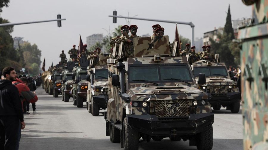 A drone view shows people gathering on the day of a military parade, as Syrians mark the first anniversary of Bashar al-Assad's fall, in Damascus, Syria December 8, 2025. REUTERS/Khalil Ashawi