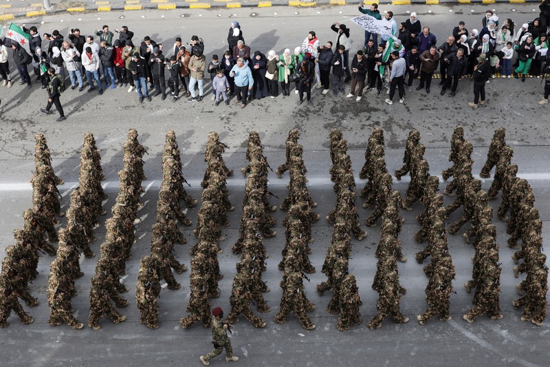 A drone view shows people gathering on the day of a military parade, as Syrians mark the first anniversary of Bashar al-Assad&#039;s fall, in Damascus, Syria December 8, 2025. REUTERS/Khalil Ashawi