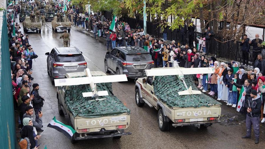 A drone view shows people gathering on the day of a military parade, as Syrians mark the first anniversary of Bashar al-Assad's fall, in Damascus, Syria December 8, 2025. REUTERS/Khalil Ashawi