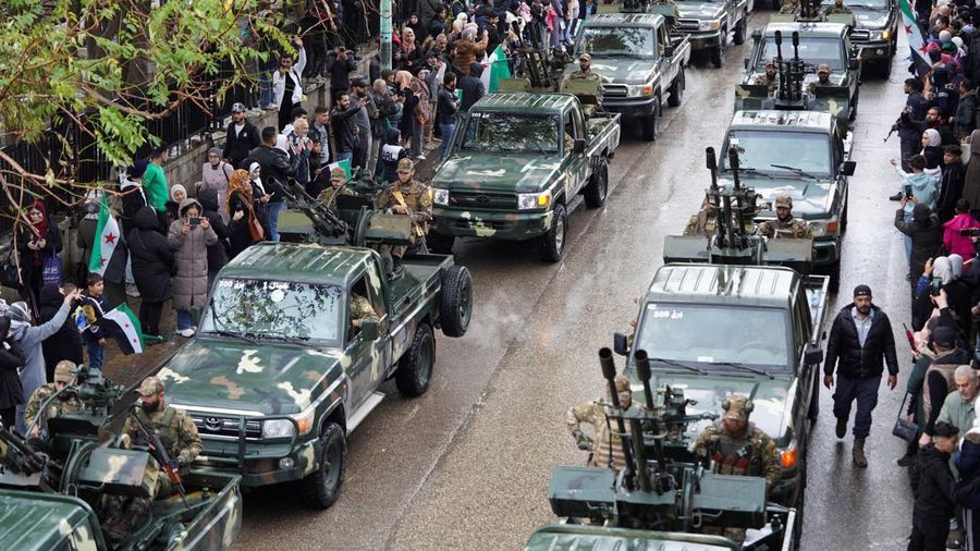 A drone view shows people gathering on the day of a military parade, as Syrians mark the first anniversary of Bashar al-Assad's fall, in Damascus, Syria December 8, 2025. REUTERS/Khalil Ashawi