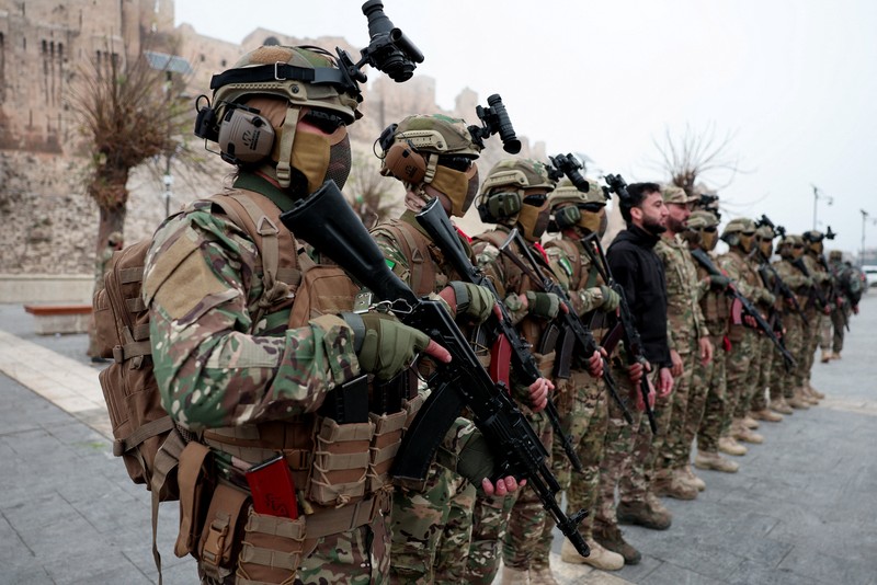 A drone view shows people gathering on the day of a military parade, as Syrians mark the first anniversary of Bashar al-Assad&#039;s fall, in Damascus, Syria December 8, 2025. REUTERS/Khalil Ashawi