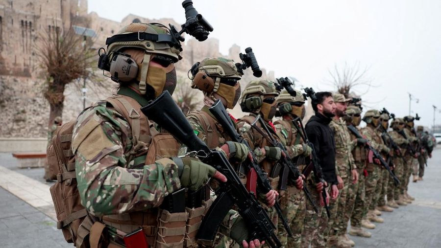 A drone view shows people gathering on the day of a military parade, as Syrians mark the first anniversary of Bashar al-Assad's fall, in Damascus, Syria December 8, 2025. REUTERS/Khalil Ashawi