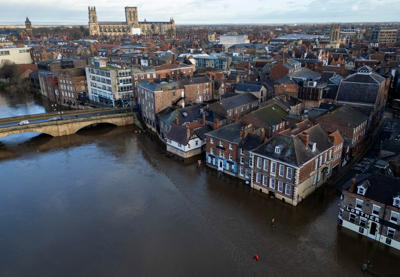 A drone view shows buildings near River Ouse, which burst its banks and partially flooded sections of nearby roads, in York, Britain, December 10, 2025. REUTERS/Phil Noble