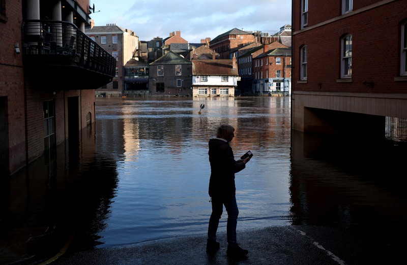 A drone view shows buildings near River Ouse, which burst its banks and partially flooded sections of nearby roads, in York, Britain, December 10, 2025. REUTERS/Phil Noble