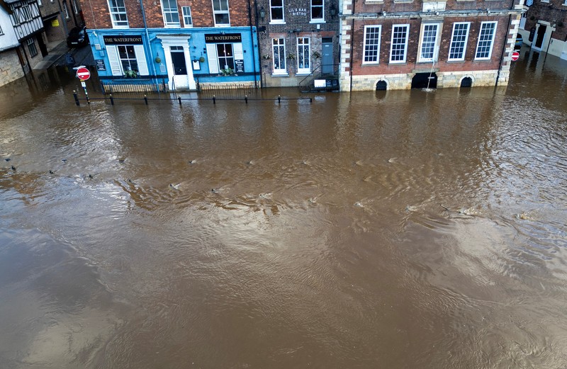 A drone view shows buildings near River Ouse, which burst its banks and partially flooded sections of nearby roads, in York, Britain, December 10, 2025. REUTERS/Phil Noble
