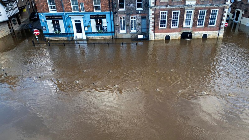 A drone view shows buildings near River Ouse, which burst its banks and partially flooded sections of nearby roads, in York, Britain, December 10, 2025. REUTERS/Phil Noble