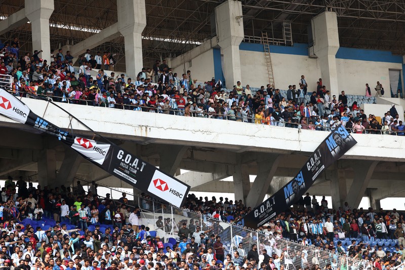 Seorang penggemar merobohkan papan reklame setelah bintang sepak bola Argentina Lionel Messi meninggalkan stadion Vivekananda Yuba Bharati Krirangan selama tur India-nya, Kolkata, India, 13 Desember 2025. (REUTERS/Sahiba Chawdhary)