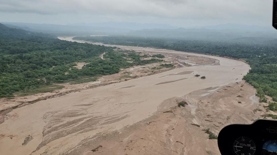 Anggota komunitas dari berbagai desa mencari orang hilang di antara puing-puing kayu setelah banjir yang dipicu oleh luapan sungai di wilayah Santa Cruz timur mengisolasi beberapa komunitas, di El Torno, Bolivia, 16 Desember 2025. (REUTERS/Claudia Morales)
