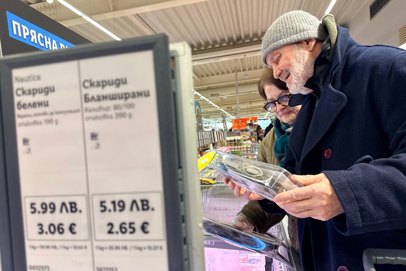 A woman shops inside a Lidl store, as prices are displayed in both the Bulgarian lev and euro currencies, ahead of Bulgaria's adoption of the euro on January 1, 2026, in Sofia, Bulgaria, December 18, 2025. REUTERS/Fedja Grulovic