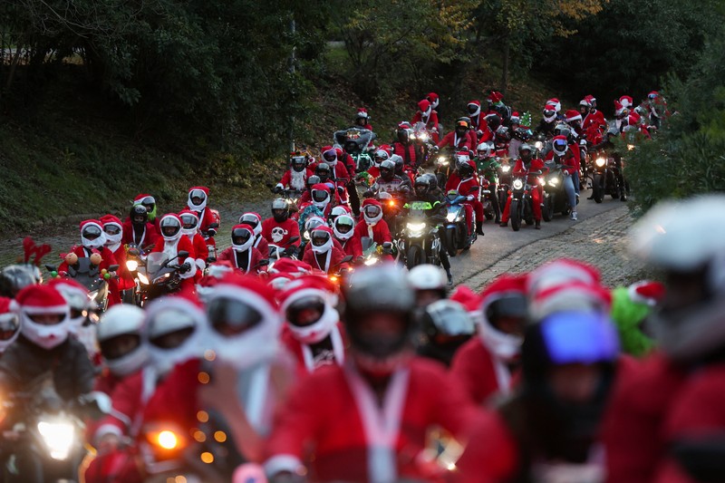 People dressed as Santa Claus ride their motorcycles through Barcelona, Spain, December 21, 2025. REUTERS/ Bruna Casas