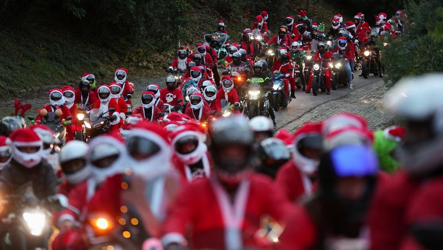 People dressed as Santa Claus ride their motorcycles through Barcelona, Spain, December 21, 2025. REUTERS/ Bruna Casas