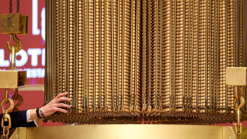 Workers operate the lottery machine, on the day of Spain's Christmas lottery 