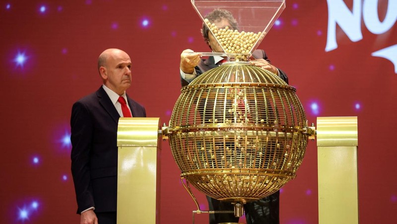 Workers operate the lottery machine, on the day of Spain's Christmas lottery 