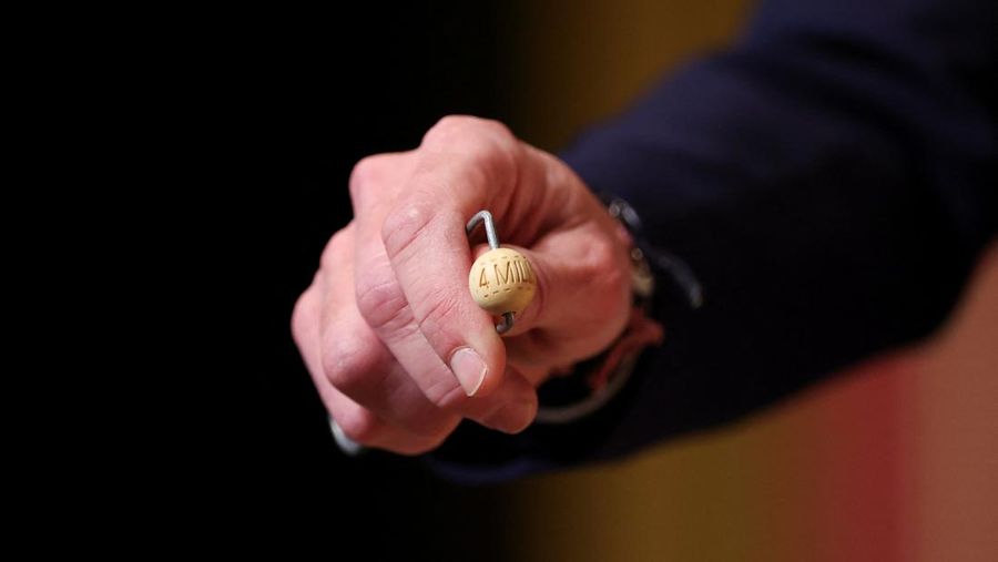 Workers operate the lottery machine, on the day of Spain's Christmas lottery 