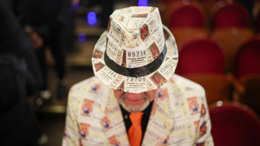 Workers operate the lottery machine, on the day of Spain's Christmas lottery 