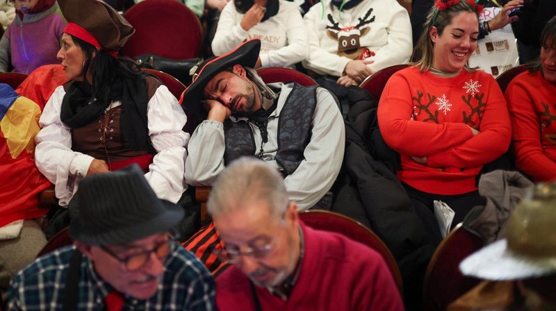 Workers operate the lottery machine, on the day of Spain's Christmas lottery 
